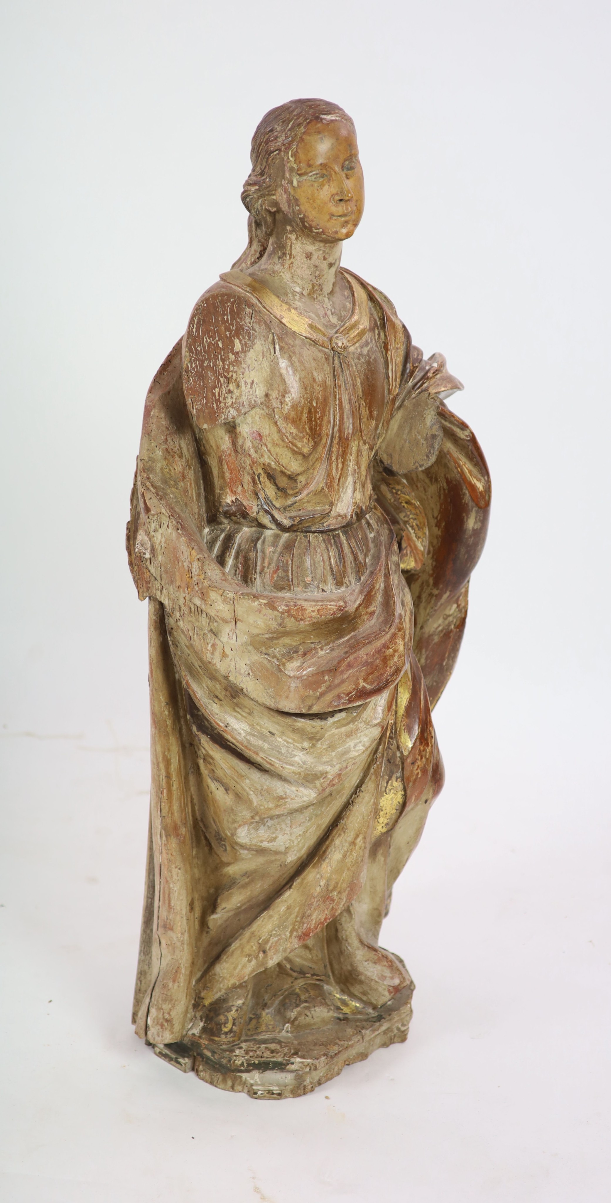 An 18th century Spanish carved wood figure of a female saint 110cm.